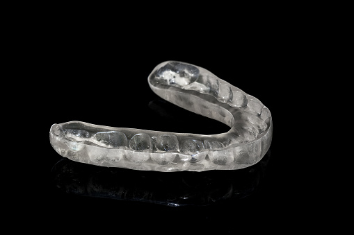 Custom dental night guard designed to prevent teeth grinding and clenching, showcasing its protective features and transparent material.
