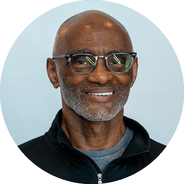 Smiling man wearing glasses and a black jacket, representing patient-centered care at Palani Center for Dental Implants in Rancho Palos Verdes.