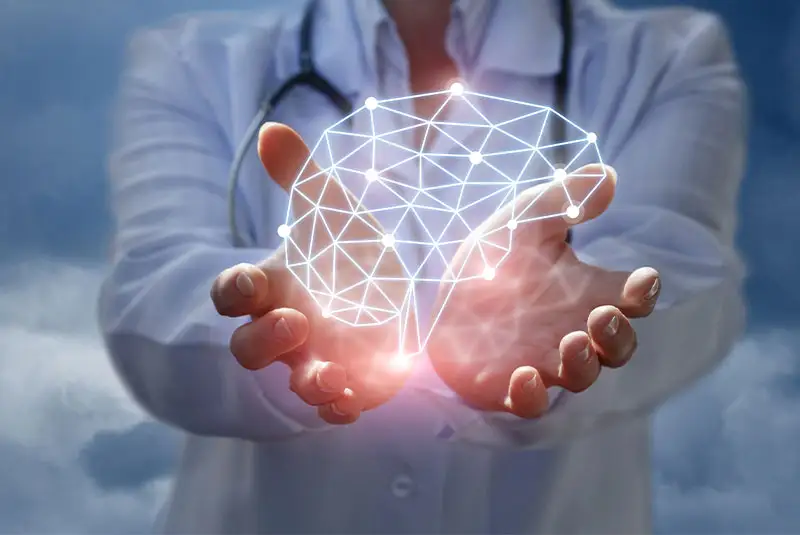 Doctor in a white coat holding a glowing, geometric representation of a brain, symbolizing holistic health and wellness in dentistry.